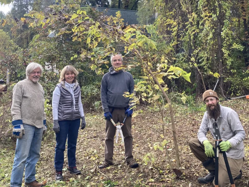 People posing after using pruning & pulling tools on invasive bittersweet vines