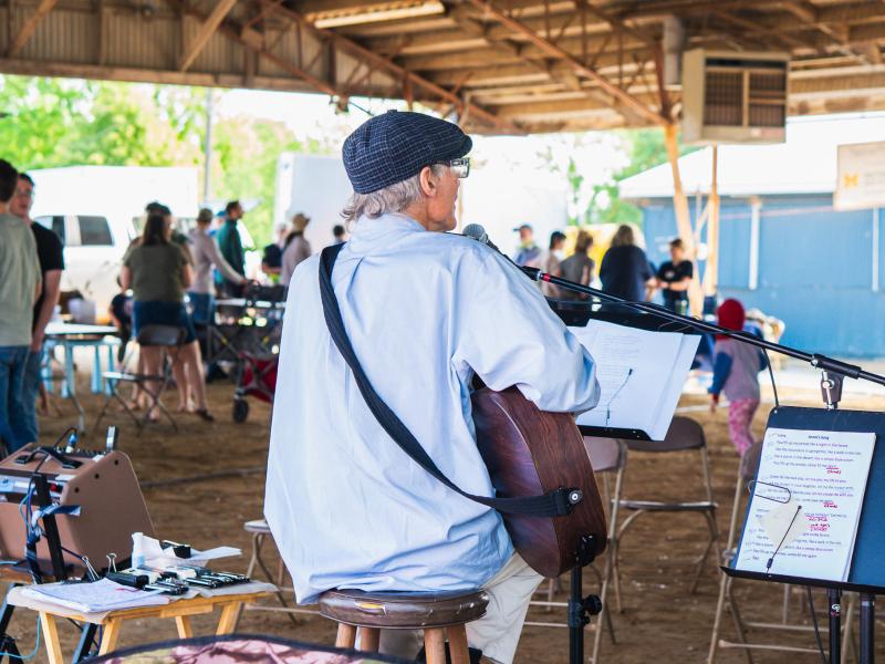 Bob Bransky performing guitar at the Native Plant Expo
