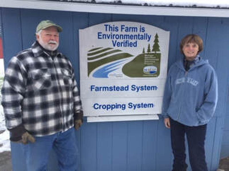 Man and woman next to MAEAP sign