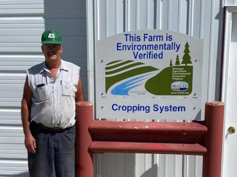 farmer with their maeap sign