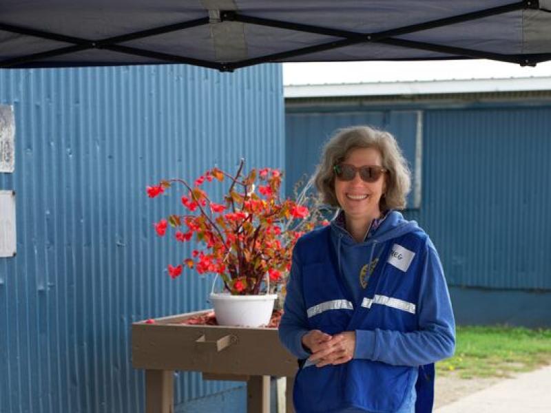 Volunteer welcoming customers (Photo Credit: Paul Michael Peters)
