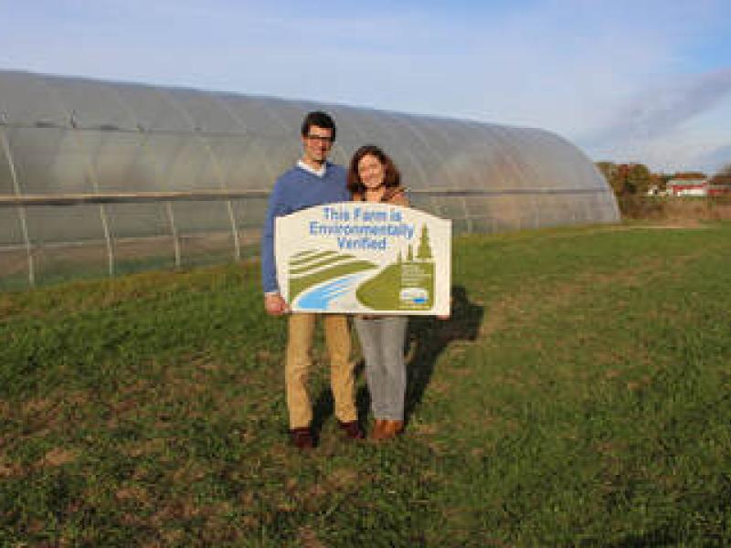 Farmers with MAEAP sign