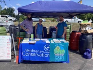 WCCD & Master Rain Gardeners distributing rain barrels at farmers market