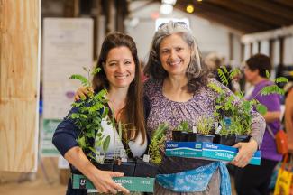 happy customers holding native plants