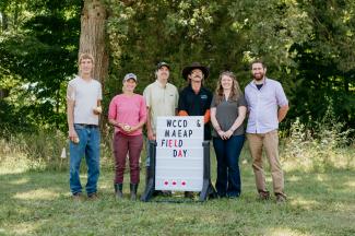 WCCD Staff standing next to a sign that reads "MAEAP Field Day"