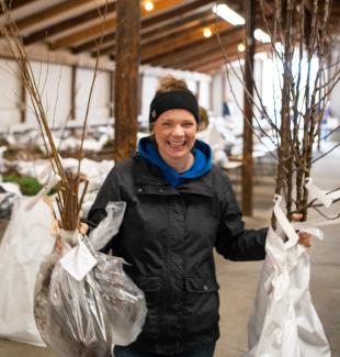 Tree Sale - Person with seedlings