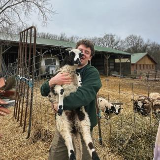 Walker holding a lamb