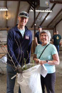 Nick Machinski and resident with tree order