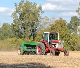 No till drill being pulled by tractor