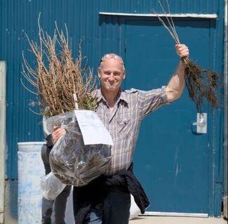 Man with bag of tree seedlings (Photo Credit: Paul Michael Peters)