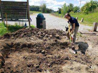 Volunteer Master Gardener Ella helping to dig our initial rain garde