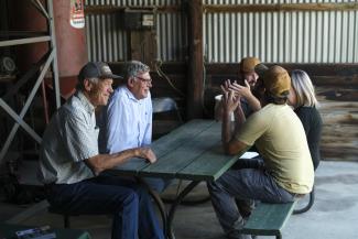 farmers talking at a picnic table