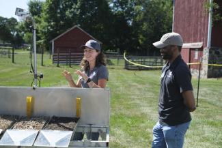 MSU staff demonstrating a rainfall simulator