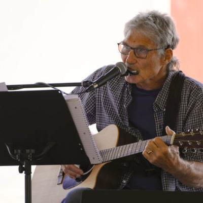 Bob Branksy performs harmonica, guitar, and singing