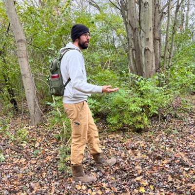 NRCS staff member walking a tree line