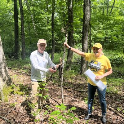 The Schoens standing by tree seedling
